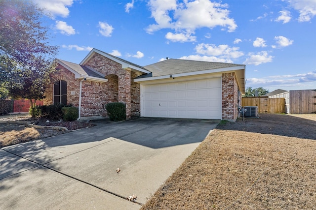 ranch-style home featuring a garage and central AC