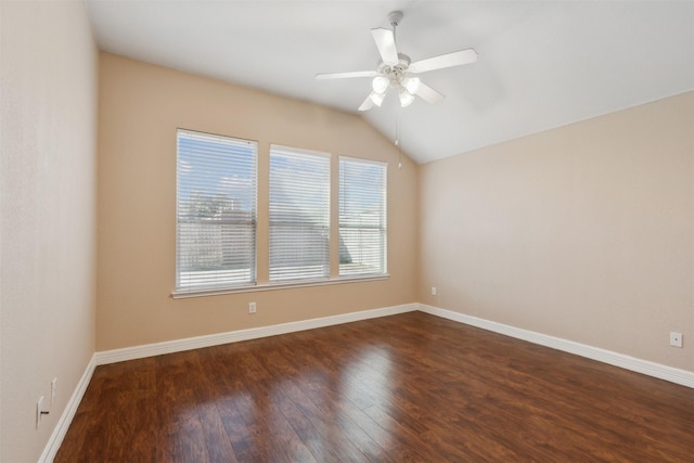 empty room with dark wood-type flooring, vaulted ceiling, and ceiling fan