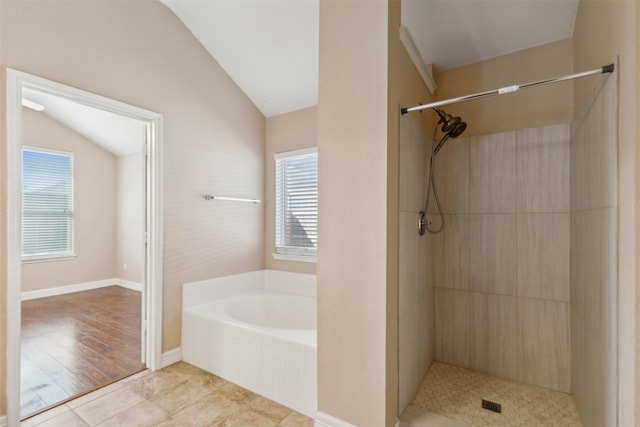 bathroom with tile patterned flooring, plus walk in shower, and vaulted ceiling