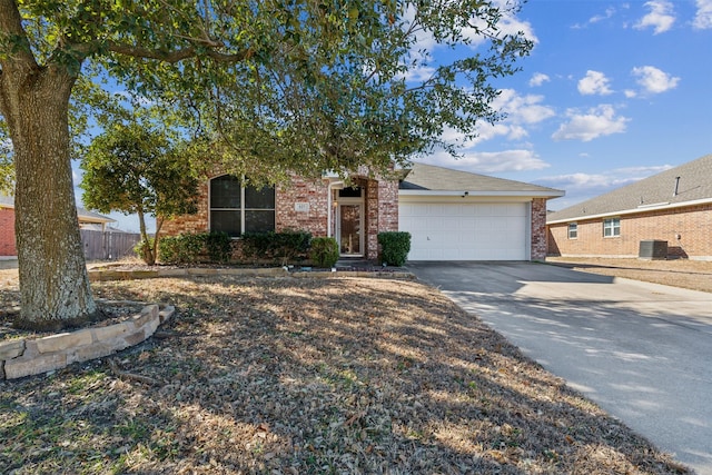 view of front of home featuring a garage and cooling unit