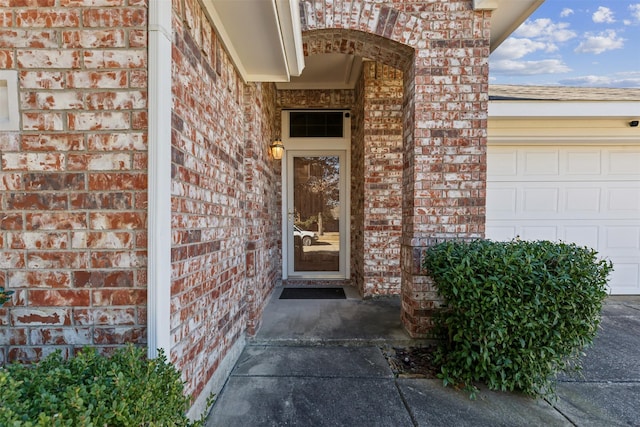 doorway to property with a garage