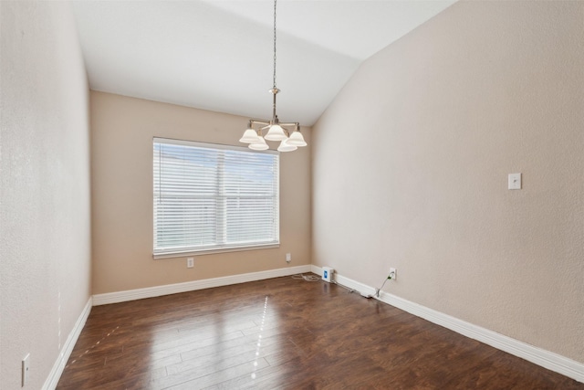 empty room featuring an inviting chandelier, vaulted ceiling, and dark hardwood / wood-style flooring