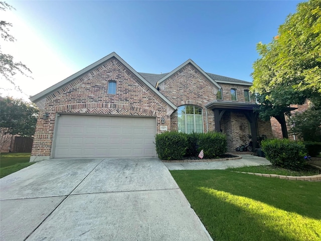 view of front of house with a front yard and a garage