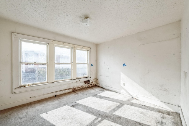 unfurnished room with a textured ceiling