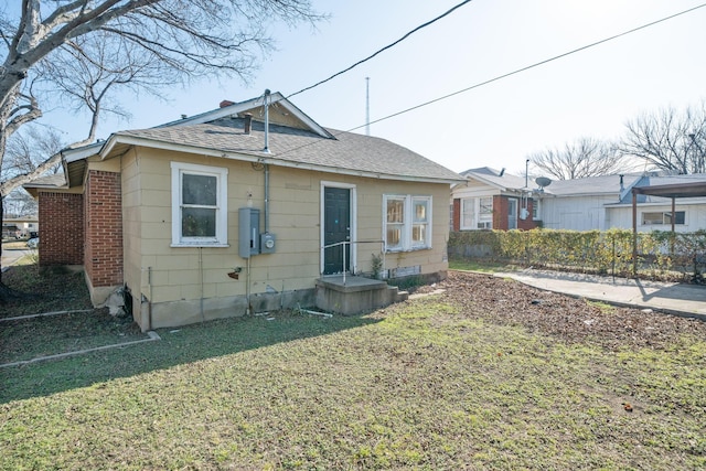 back of property featuring a lawn