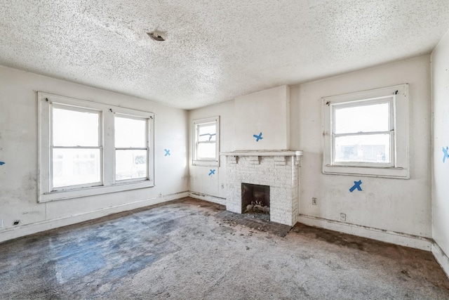 unfurnished living room with a textured ceiling and a fireplace