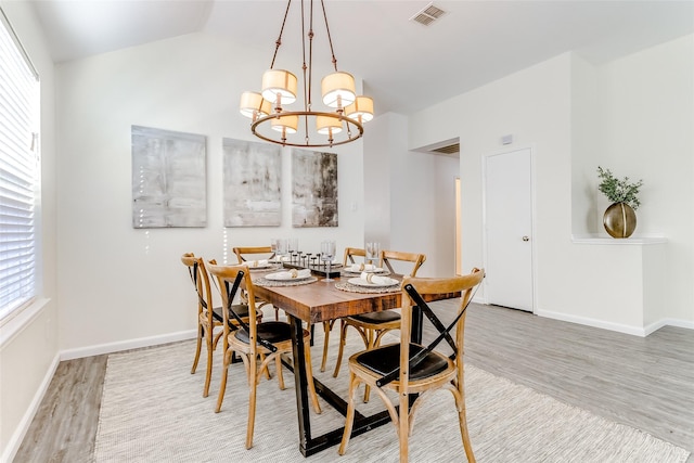 dining room featuring wood-type flooring and a notable chandelier