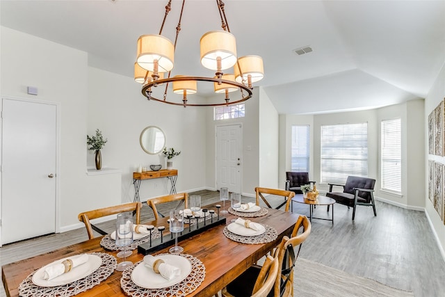 dining area featuring light hardwood / wood-style floors and a notable chandelier