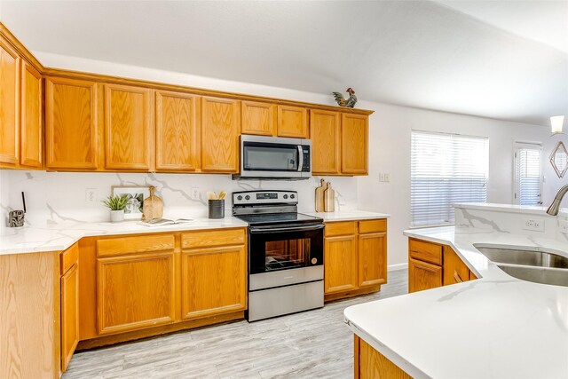 kitchen featuring sink, stainless steel appliances, and light wood-type flooring