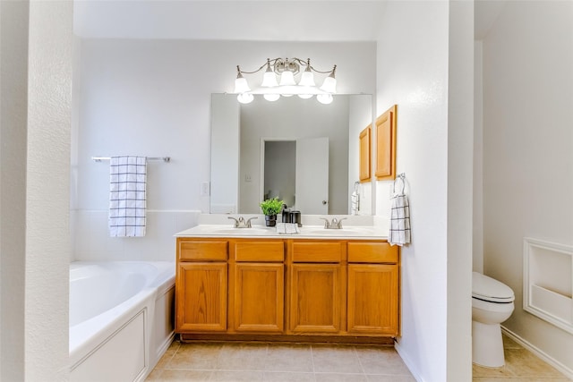 bathroom with toilet, vanity, tile patterned floors, and a bathing tub