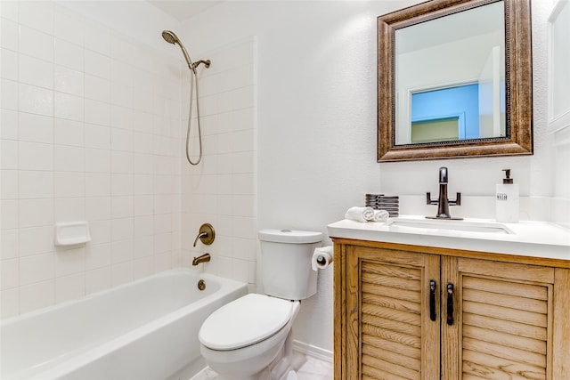 full bathroom featuring tiled shower / bath, vanity, and toilet