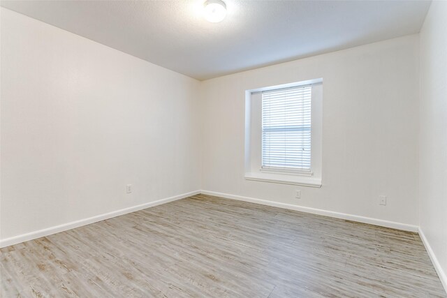 spare room with light hardwood / wood-style floors