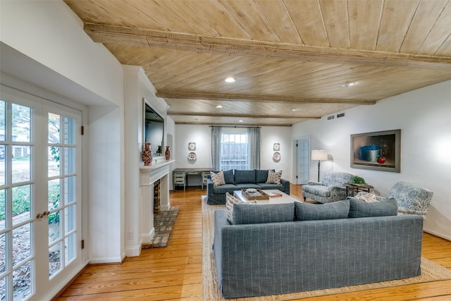 living room with beamed ceiling, french doors, light hardwood / wood-style flooring, and wood ceiling