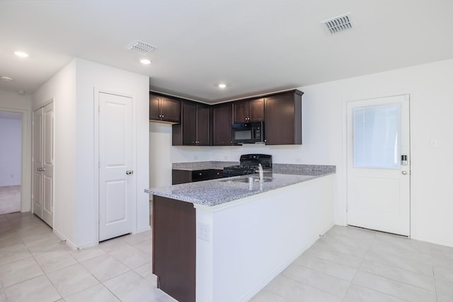 kitchen featuring dark brown cabinetry, light stone countertops, sink, kitchen peninsula, and black appliances