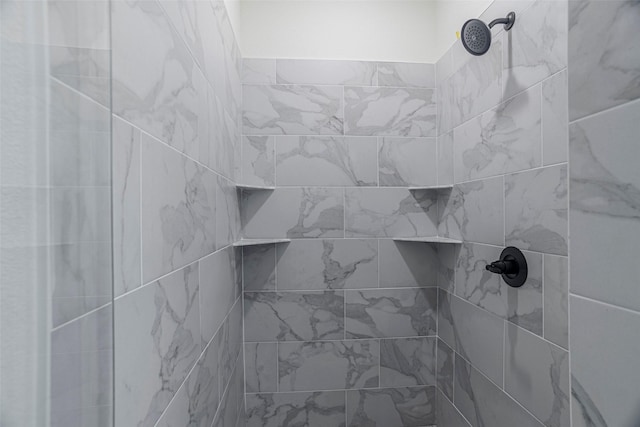 interior details with a tile shower