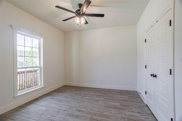 unfurnished room with ceiling fan and light hardwood / wood-style flooring