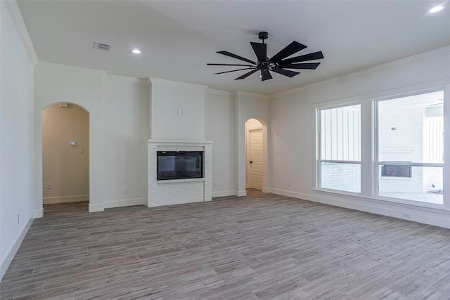 unfurnished living room featuring light wood-type flooring, ceiling fan, and crown molding