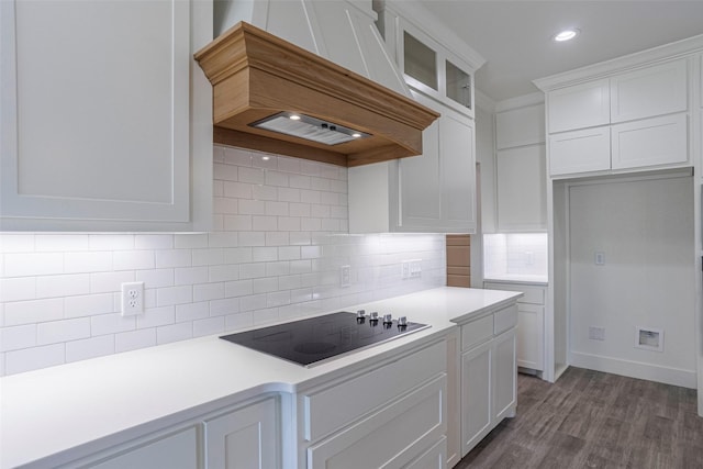 kitchen with custom exhaust hood, white cabinetry, decorative backsplash, and black electric cooktop