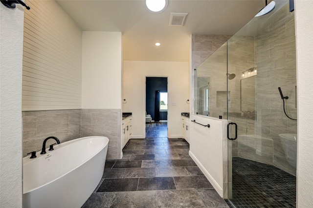 bathroom featuring vanity and separate shower and tub