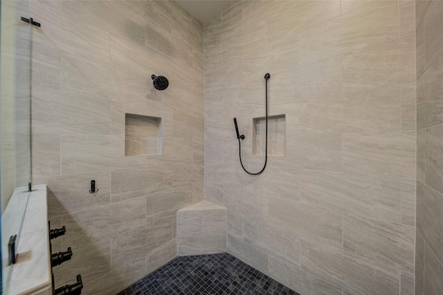 bathroom with a tile shower