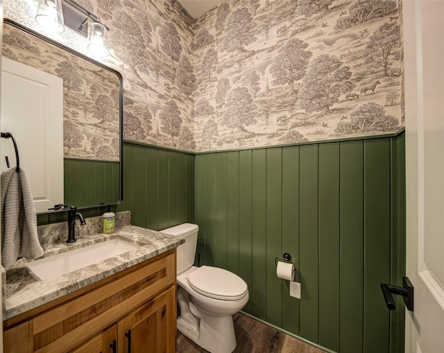 bathroom featuring vanity, hardwood / wood-style flooring, and toilet