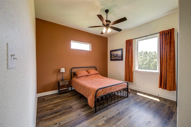 bedroom with dark wood-type flooring and ceiling fan