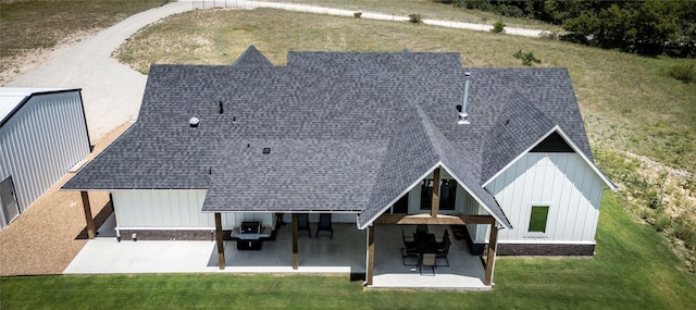 rear view of property with a patio area and a lawn