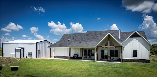 rear view of property featuring a yard and a patio area