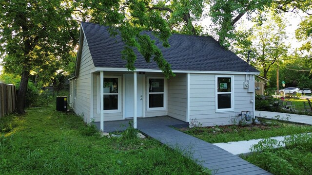 bungalow-style house with a front yard and central AC