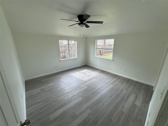 spare room with ceiling fan and light wood-type flooring