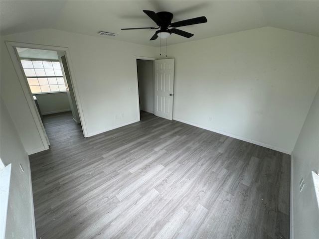 unfurnished bedroom featuring ceiling fan, wood-type flooring, and vaulted ceiling