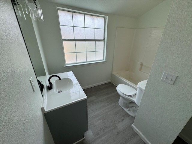 full bathroom featuring vanity, toilet,  shower combination, and hardwood / wood-style floors