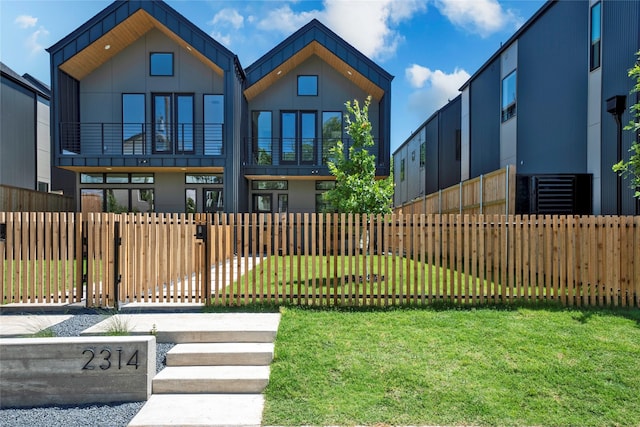 contemporary home with a front lawn