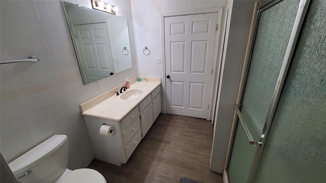 bathroom featuring vanity, wood-type flooring, and toilet