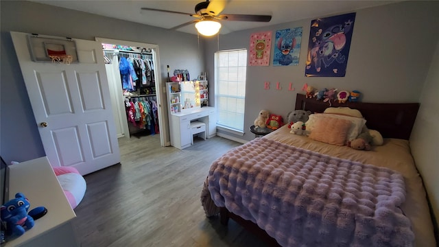 bedroom with ceiling fan, wood-type flooring, and a closet