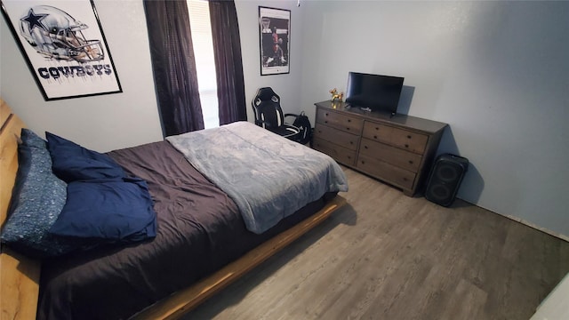 bedroom with wood-type flooring