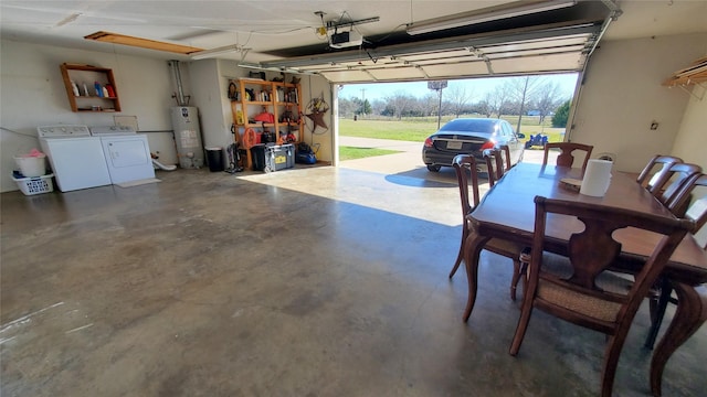 garage with washing machine and dryer, water heater, and a garage door opener