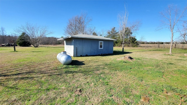 view of yard featuring an outbuilding and a rural view