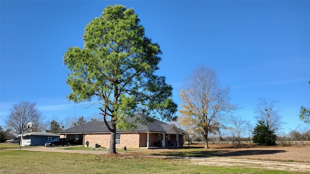 exterior space with a carport and a front yard