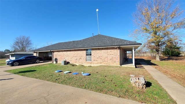 view of property exterior featuring central air condition unit, a yard, and a carport