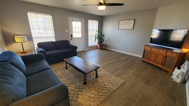 living room with dark hardwood / wood-style floors and ceiling fan