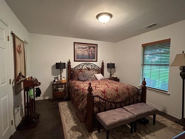 bedroom with dark colored carpet