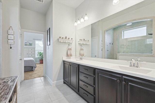 bathroom featuring tiled shower, vanity, and tile patterned floors