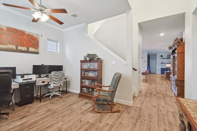 office space featuring light hardwood / wood-style flooring, ceiling fan, and crown molding