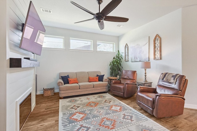 living room with hardwood / wood-style flooring and ceiling fan