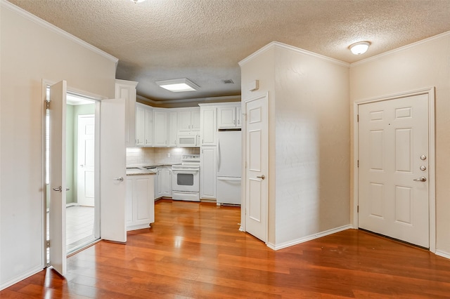 kitchen with tasteful backsplash, white cabinetry, ornamental molding, white appliances, and light wood-type flooring