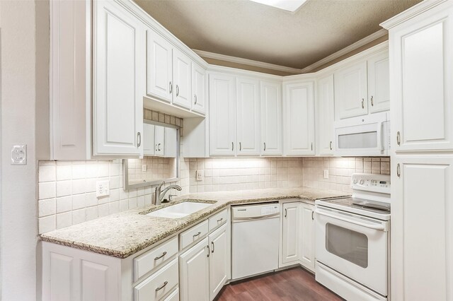 kitchen featuring light stone counters, white appliances, sink, dark hardwood / wood-style floors, and white cabinetry