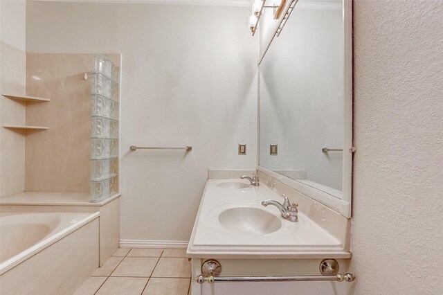 bathroom with a bath, tile patterned flooring, and sink