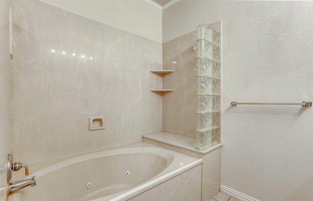 bathroom with a tub and crown molding