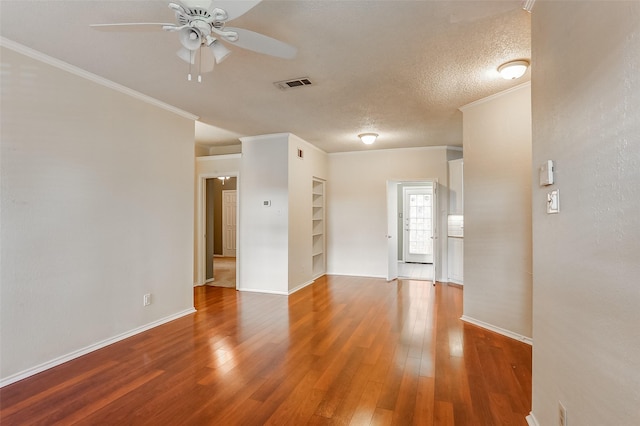 unfurnished room featuring ornamental molding, hardwood / wood-style floors, and a textured ceiling